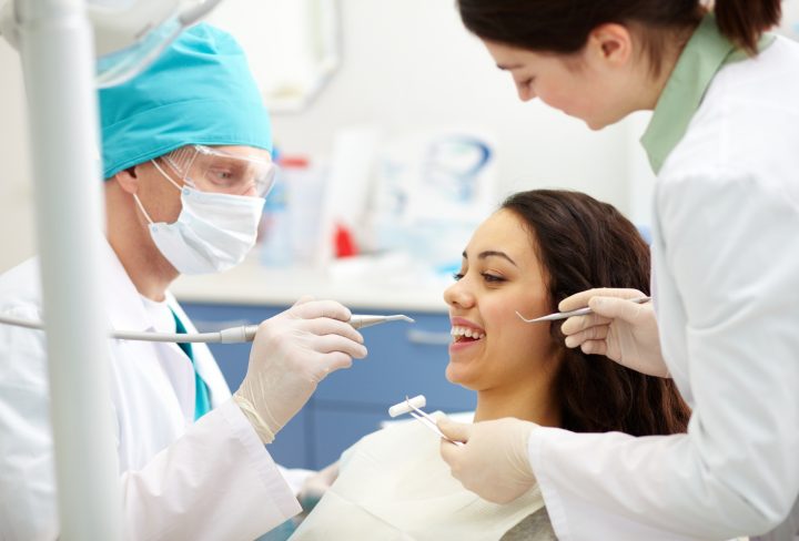 dentist-examining-patient-s-teeth